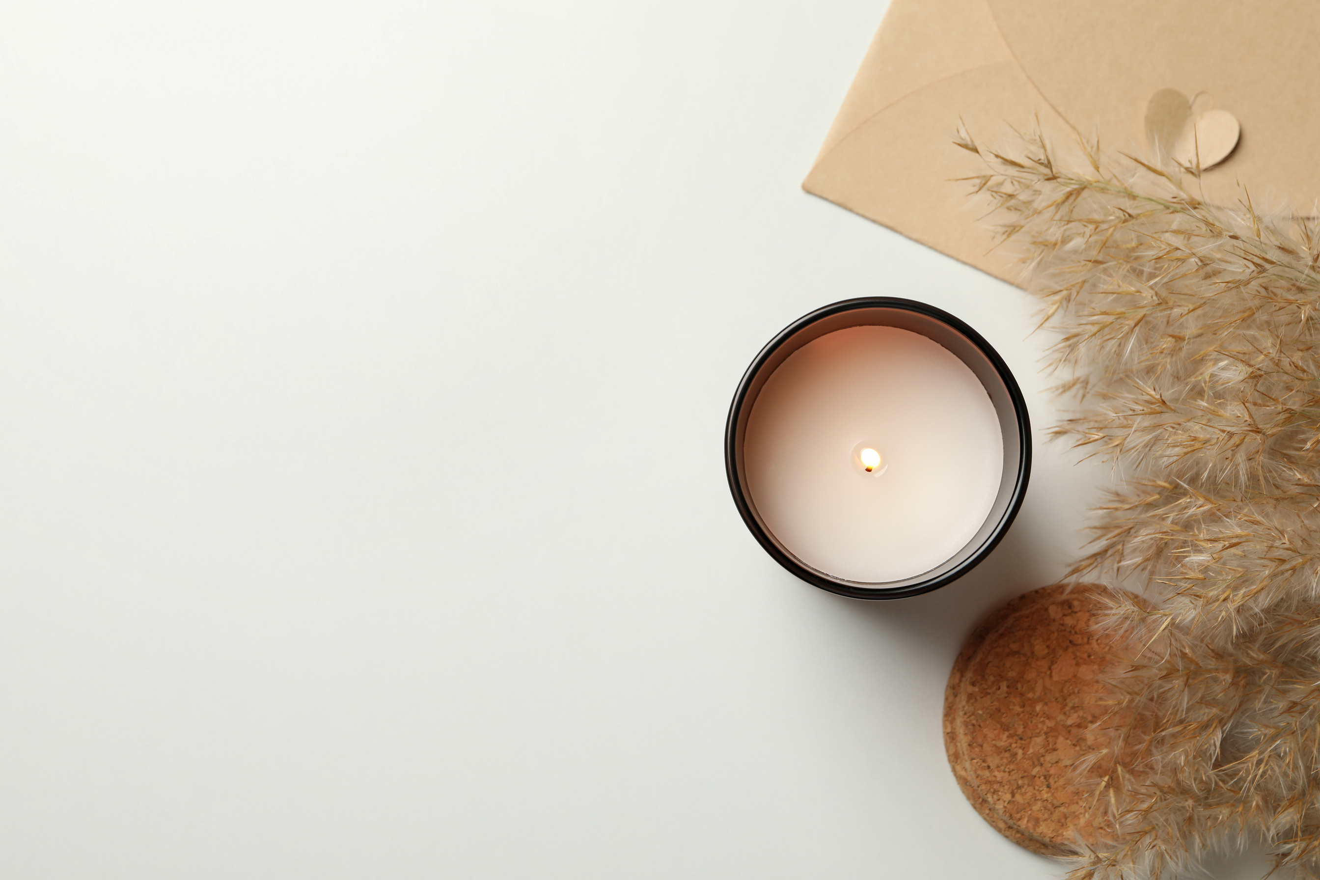 Scented Candle, Envelope and Reed Grass on White Background